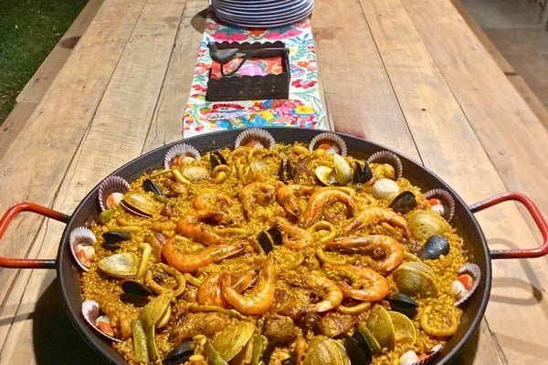 Paella mar y tierra sobre una mesa campestre